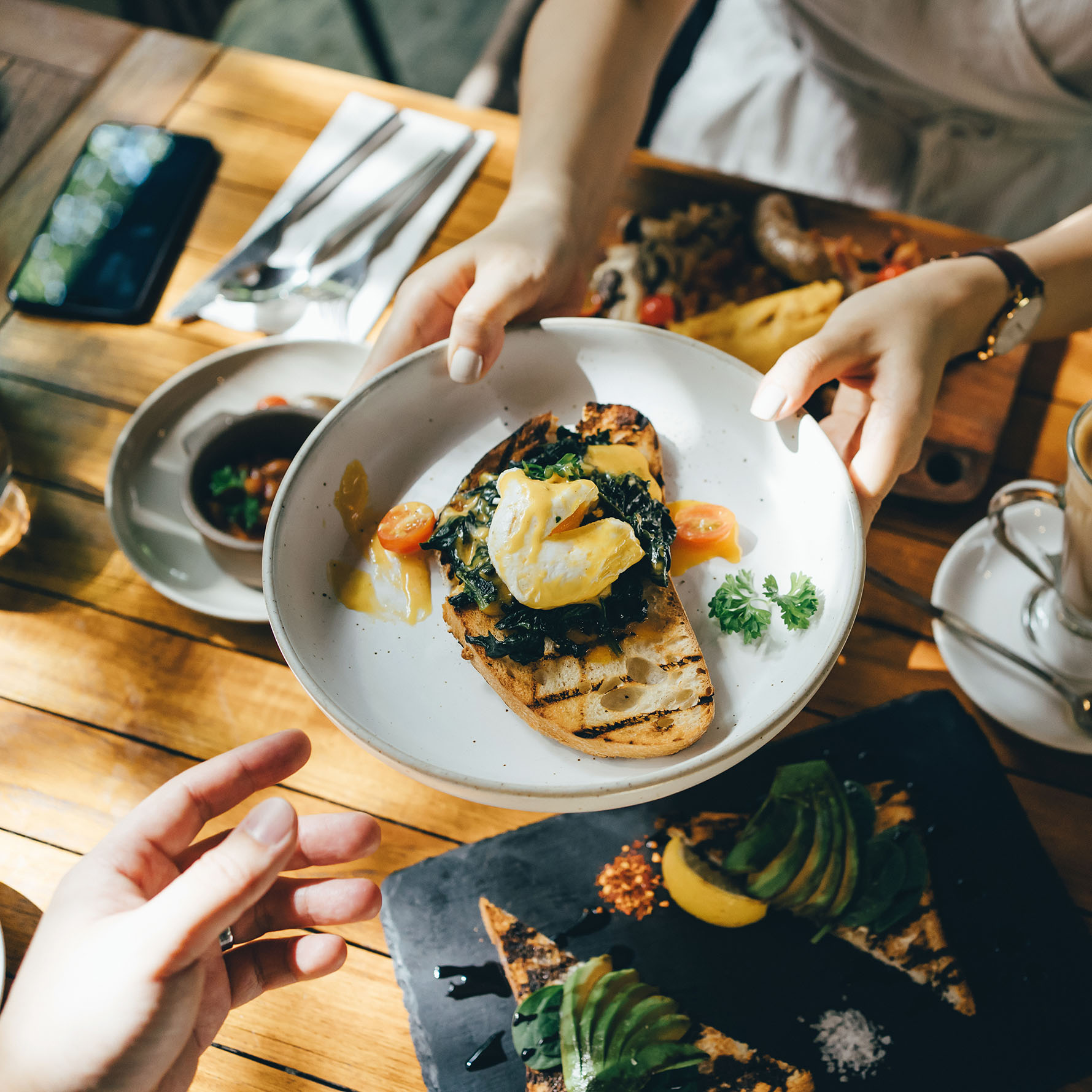 passing food over a table