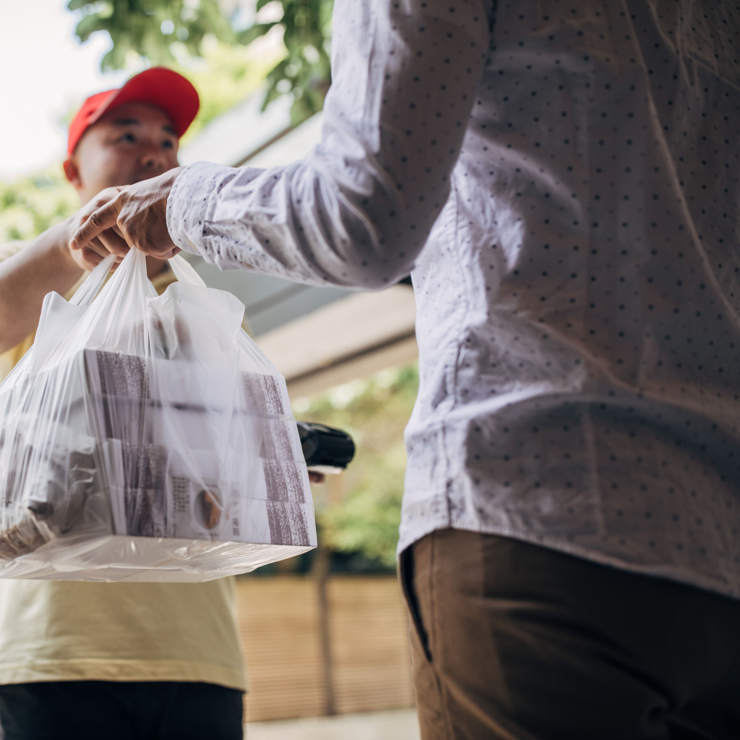 delivery man bringing food to a customer with a lot of packaging